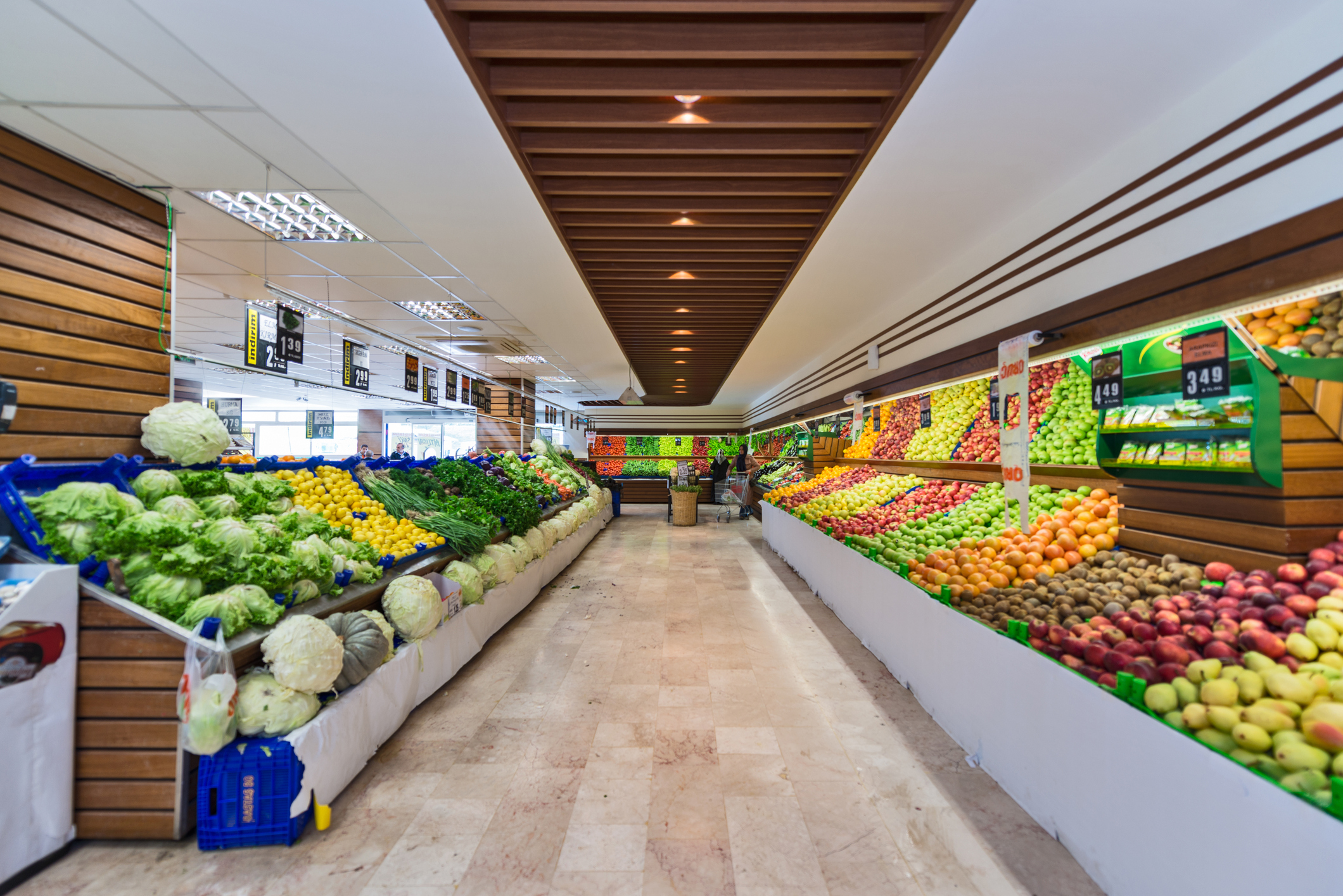 Produce Section in a Supermarket - A supermarket, a large form of the traditional grocery store, is a self-service shop offering a wide variety of food and household products, organized into aisles. It is larger in size and has a wider selection than a traditional grocery store, but is smaller and more limited in the range of merchandise than a hypermarket or big-box shop. The supermarket typically comprises meat, fresh produce, dairy, and baked goods aisles, along with shelf space reserved for canned and packaged goods as well as for various non-food items such as household cleaners, pharmacy products and pet supplies. Most supermarkets also sell a variety of other household products that are consumed regularly, such as alcohol (where permitted), medicine, and clothes, and some stores sell a much wider range of non-food products.